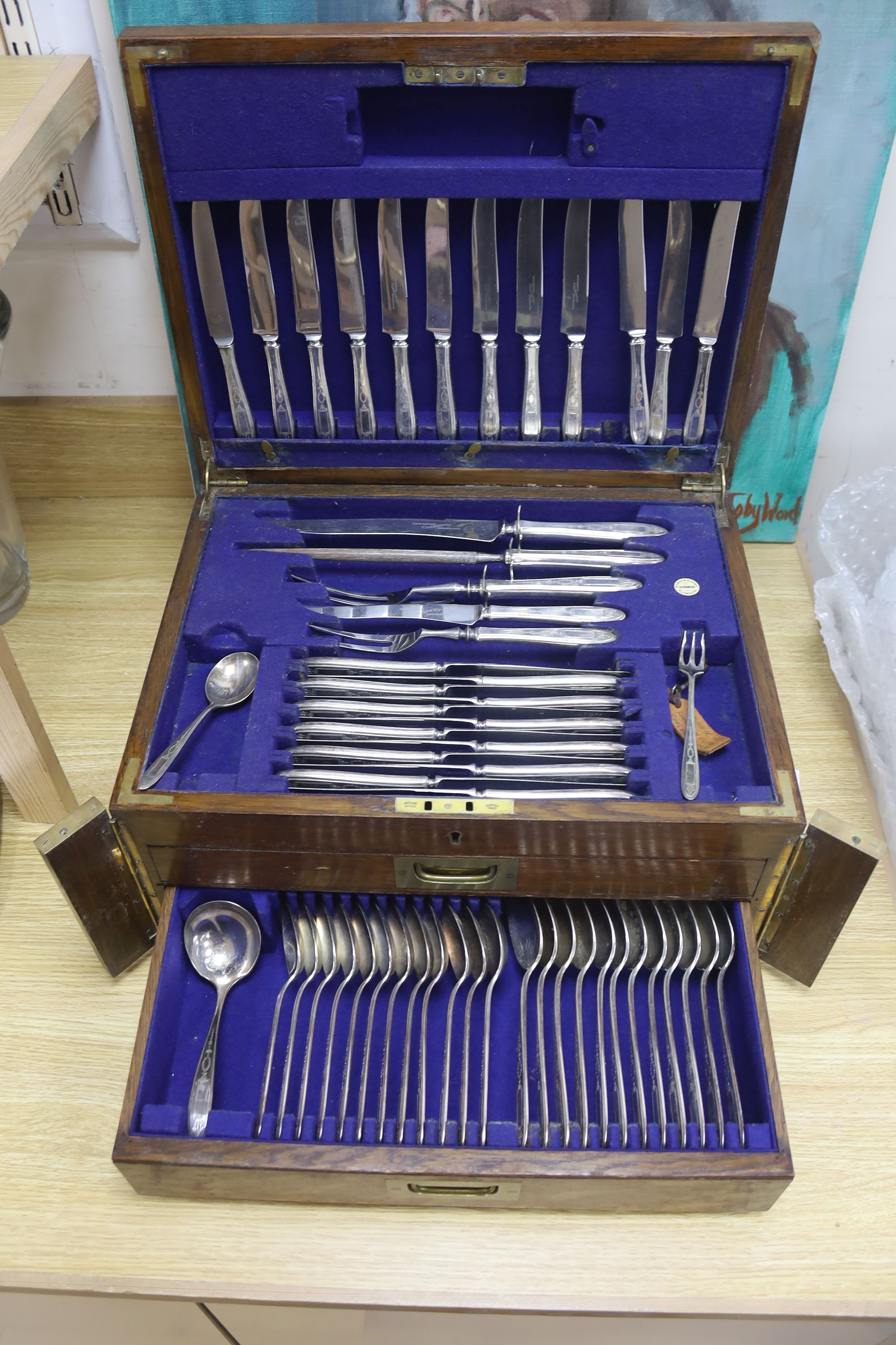 A large early 20th century oak cutlery canteen containing a large quantity of stainless steel cutlery, width 45cm depth 35cm height 23c